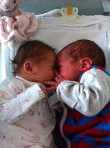 Twins - Sofia (left) meeting Lee for the first time after 12 days in special care