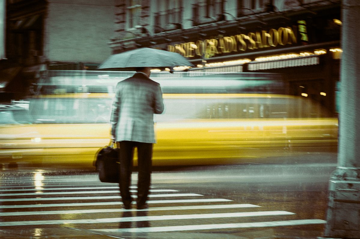 I shot this image in agust 2013 during my stay in NYC. It started to rain in the afternoon and while hiding from the rain and saw this man, standing on the street with his umbrella. I totally forgot to set a higher ISO and so I got this "shacky" image. 