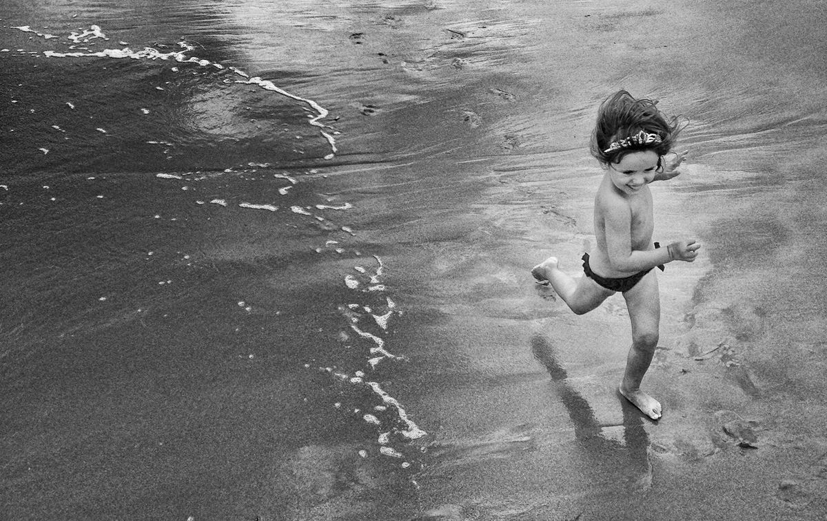 My daugther running on the beach