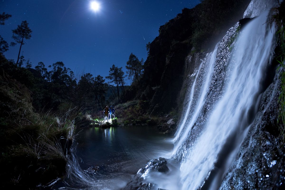 "Night Explorers" : is a night photo and had high trouble shooting  To be able to shoot this angle I had to go into the water, which by the way was Fu%&$ cold.. I ended up getting wet while trying to protect the lens of any spillage from the waterfall.  Behind the models have two continuous light sources, one focus is directed towards the rear of the models to create light silhouette and the other focus of lower intensity is focusing in the cascade.  after a 10 second exposure I could capture this, in my opinion, is different than usual..  Hope you enjoy this result  Best Regards