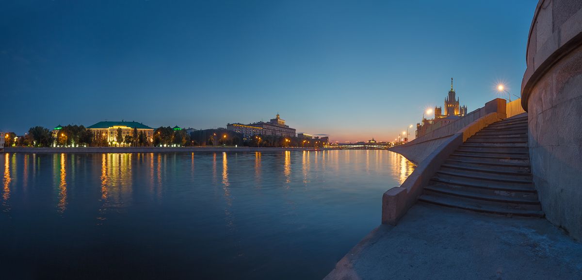 Warm quiet summer evening on the embankment of the river of Moscow. Moscow, Russia. Panorama of 18 shots.